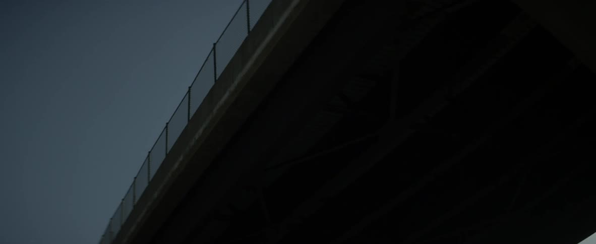 A truck passes on the overpass above