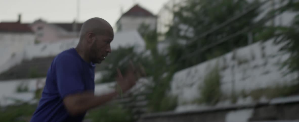 A man sprints up old stadium bleachers