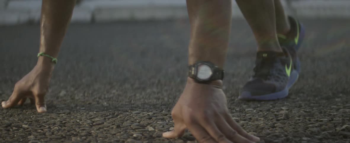 Man getting into his racing pose to start a race as seen from ground level