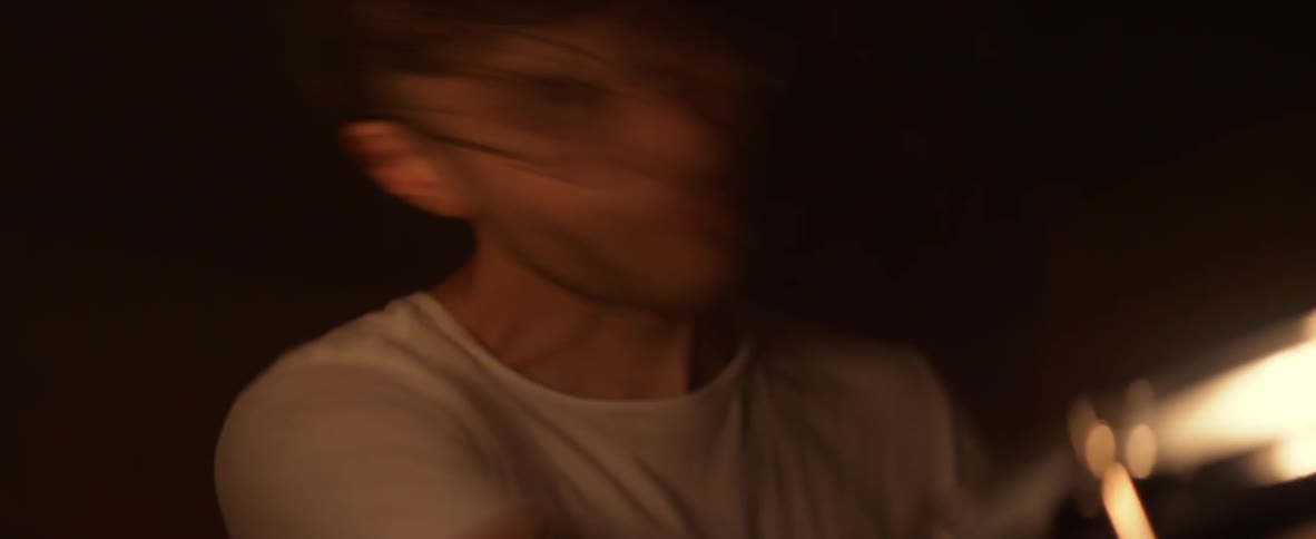 A man is slamming his drum sticks into the drums