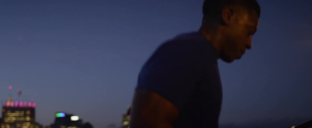 Man running up stairs outside in the city at night