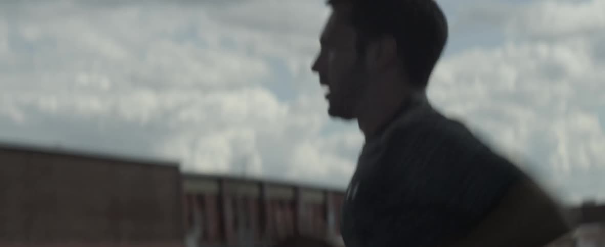 Man jogs under a cloudy sky