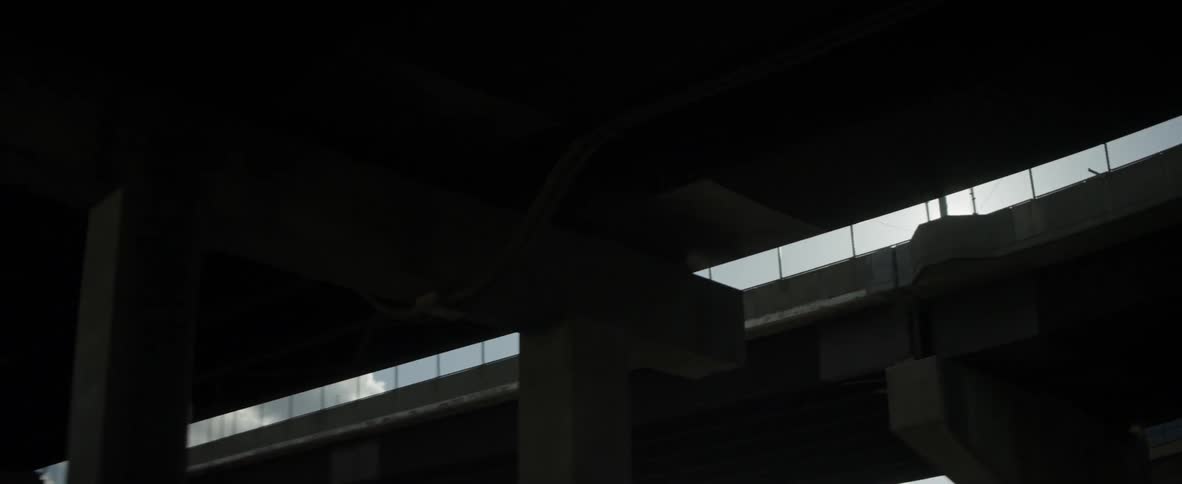 It is very dark under the overpass
