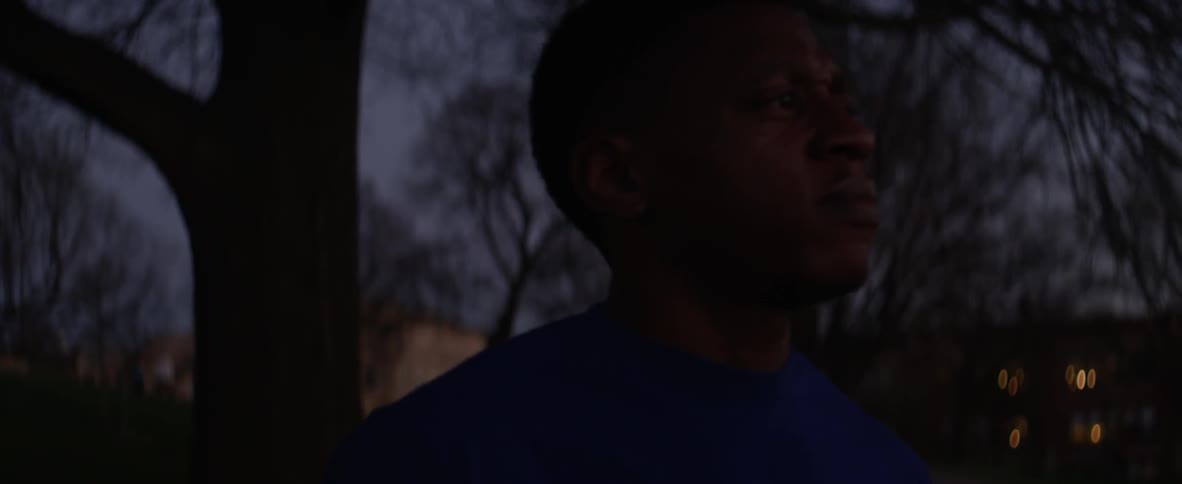 A man stretches and loosens up outside