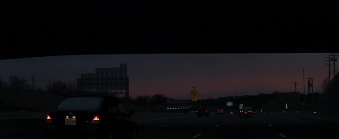 Cars travel down the highway at dawn