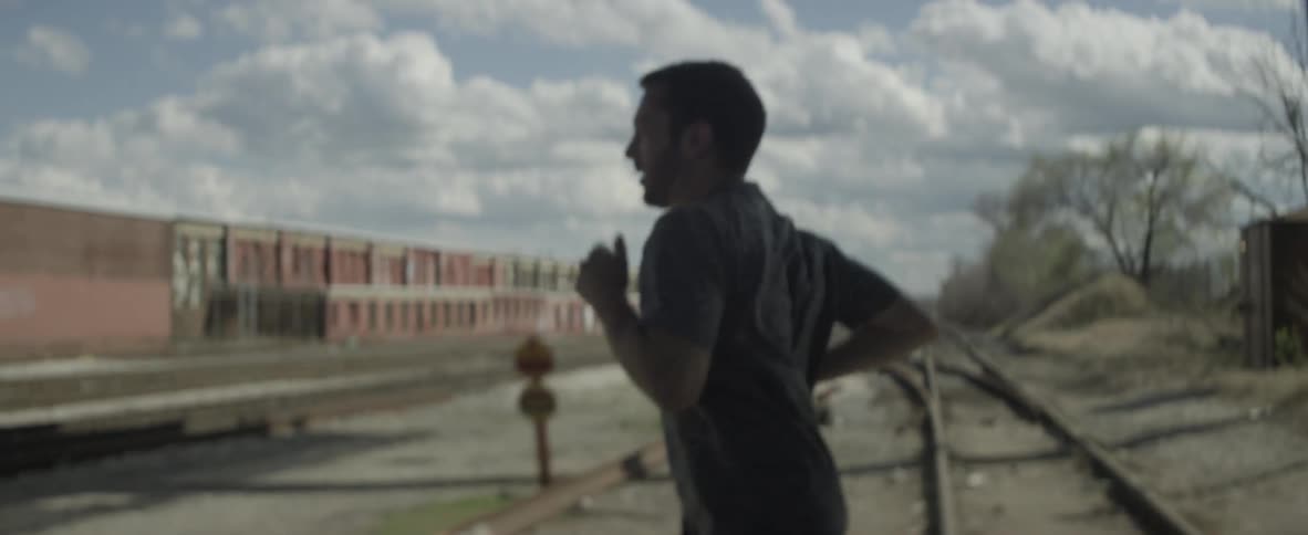 A man is running down the sidewalk in town