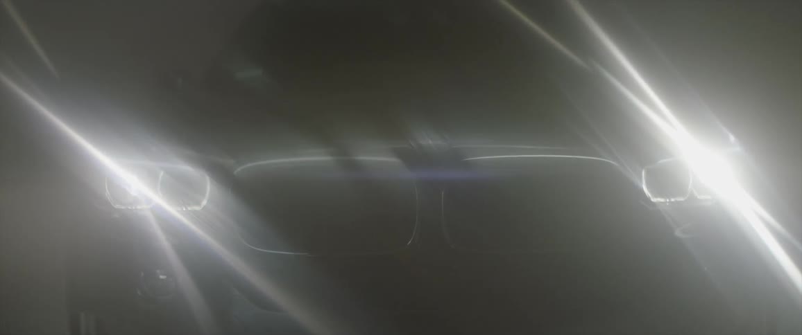 A car's headlights shine