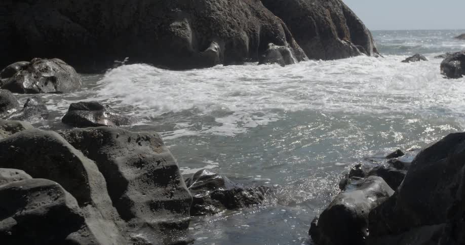 Ocean waves crash into a rocky shore