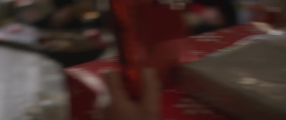 Man with a stack of gifts on his lap receives more