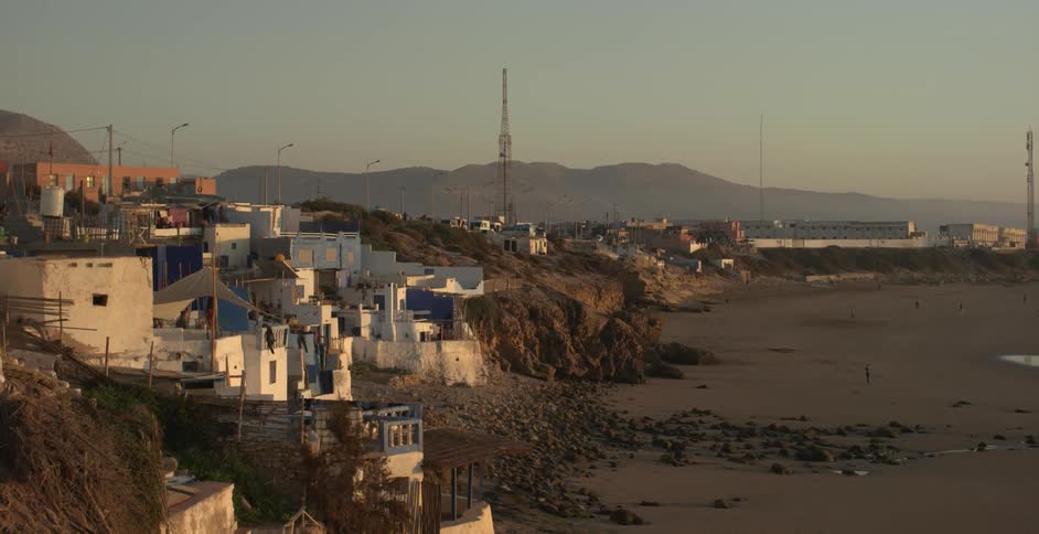Buildings line a sandy beach