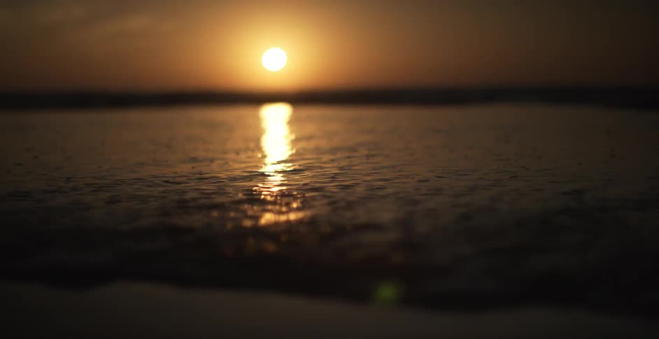 The sun is setting over the ocean ahead