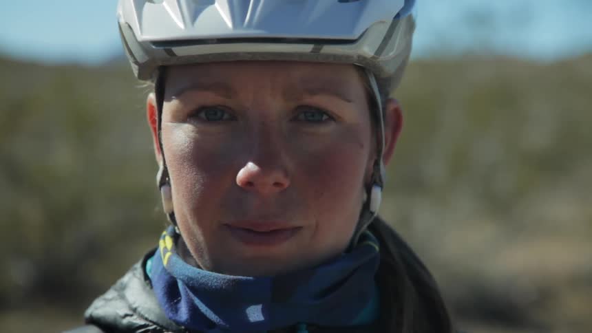 A woman is looking forward with a helmet