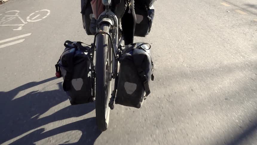A person is riding a bicycle on a sunny day