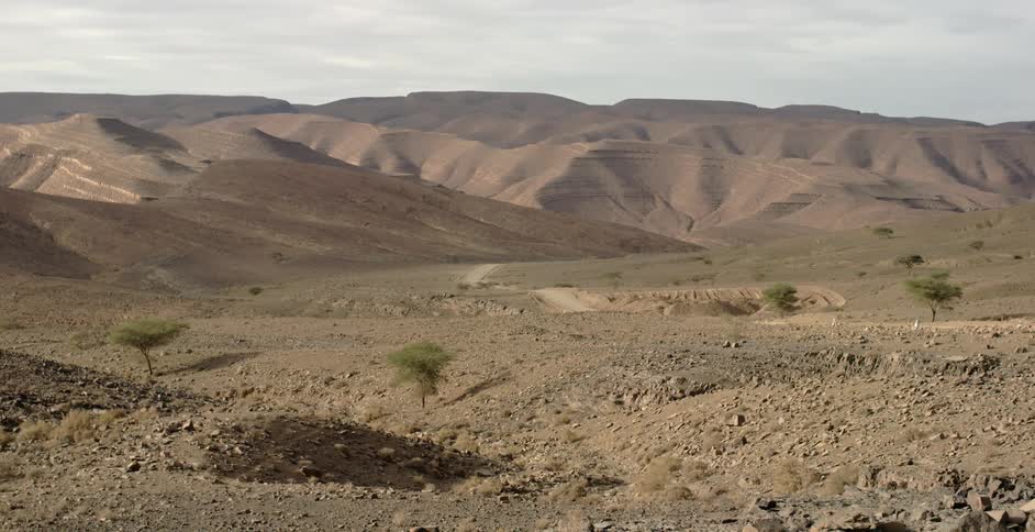 A hilly desert area is shown on a sunny day