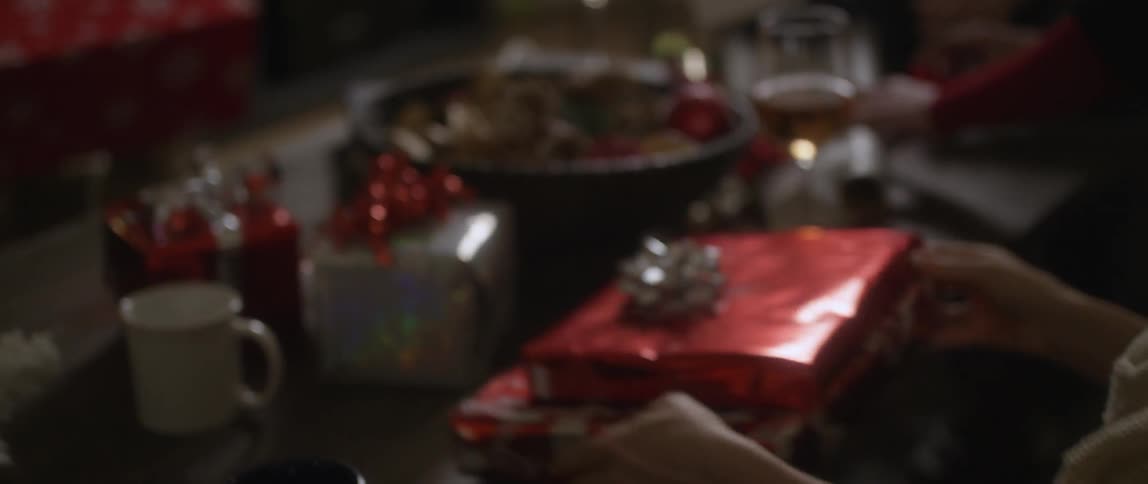 Person placing presents on a crowded table