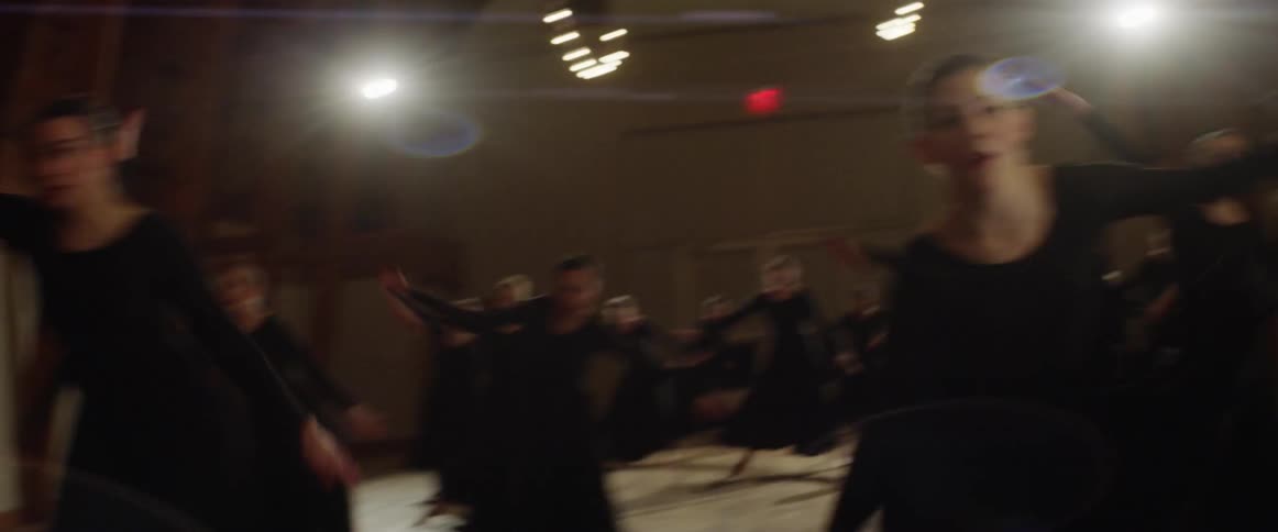 Group of people all dance the same dance
