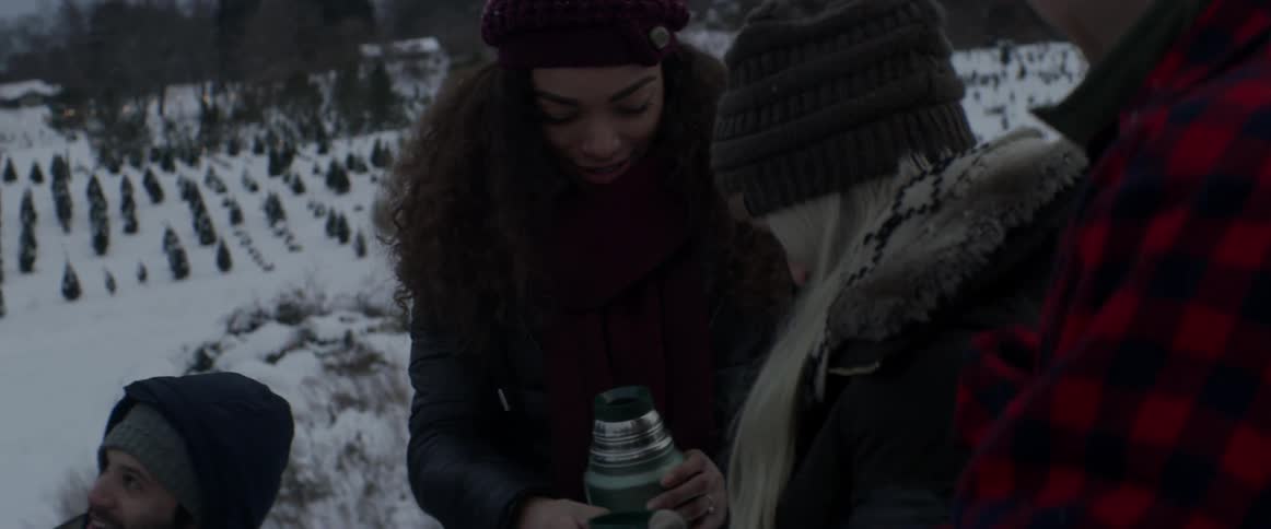 People talk and have a drink from a thermos