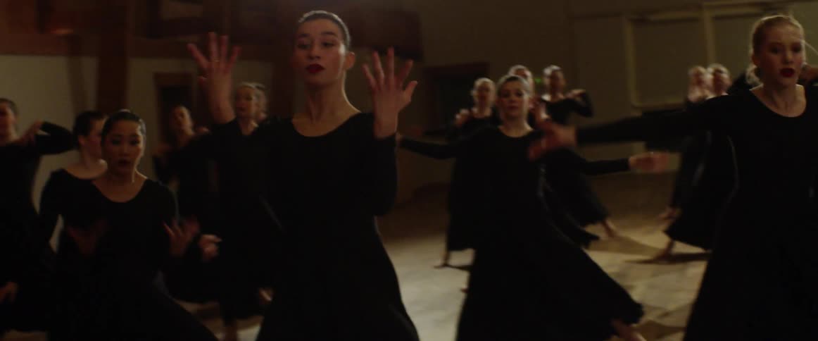 A dance team rehearses in a studio