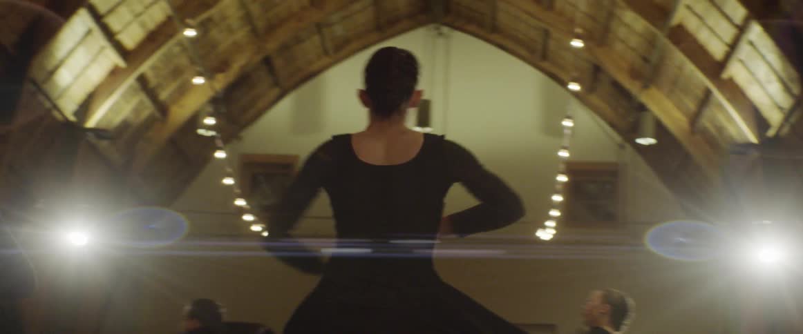 A bunch of women are dancing in a hall