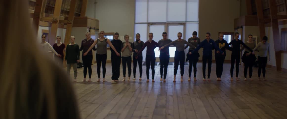 Line of people start walking forwards towards an instructor