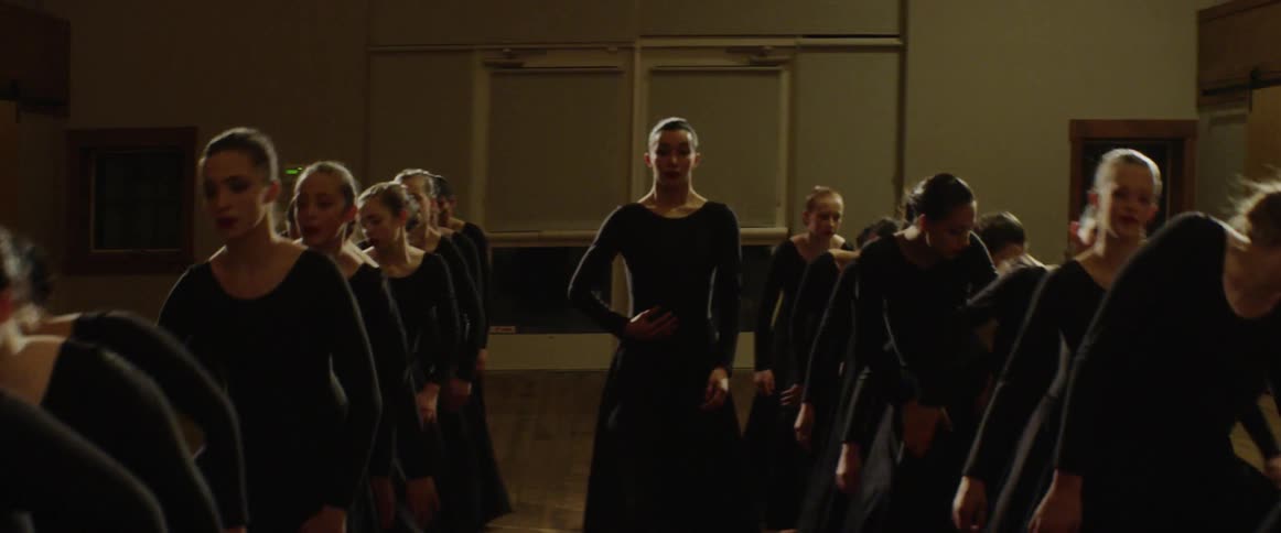Women line up in order wearing all black