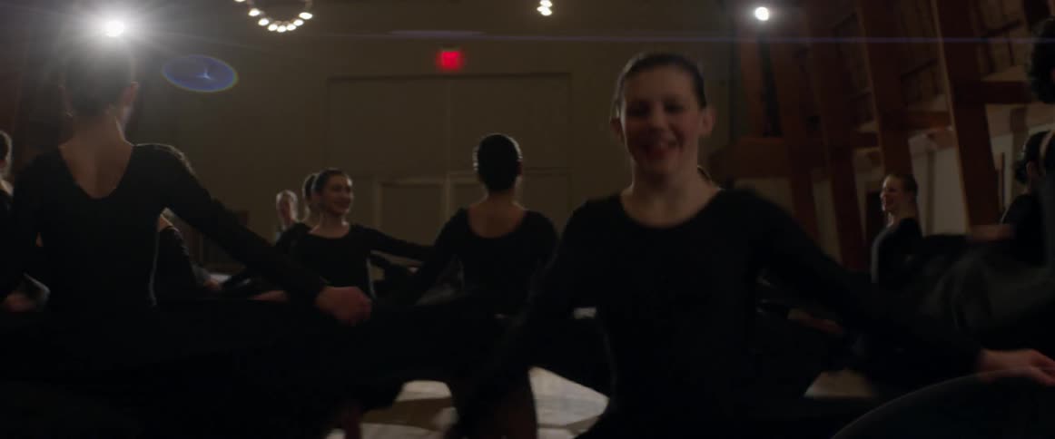 Women dancing and spinning their skirts about in unison in a studio