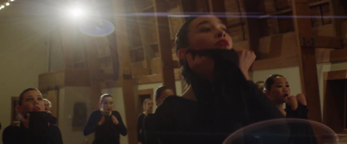 A group of dances in a brightly lit room