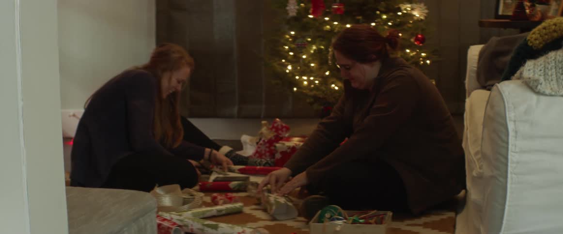 Two women wrapping christmas presents
