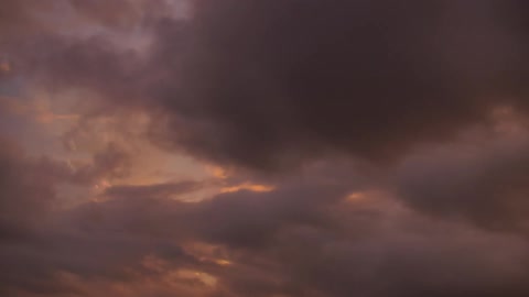 Clouds move along the sky at dawn