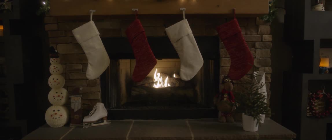 Christmas stockings hung over a blazing fireplace