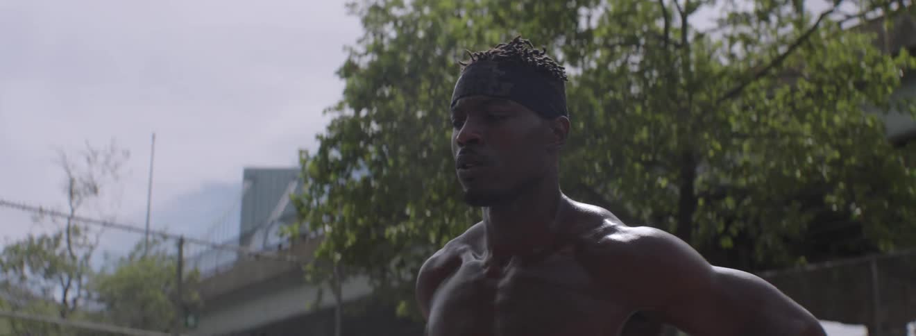 A man is standing outside stretching