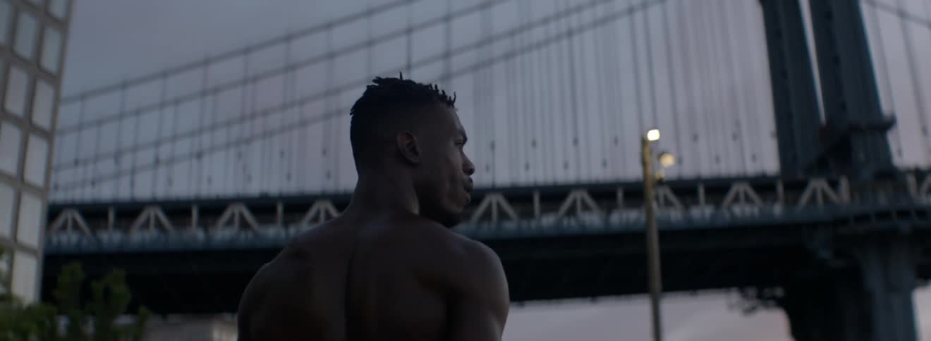 A man walks towards the bridge