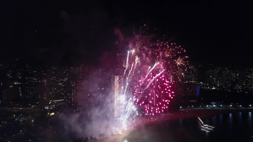Huge fireworks shoot out over the city at night