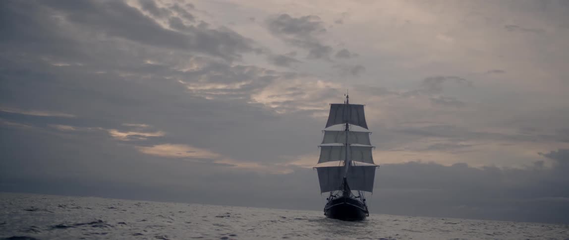 A large boat sails in the rough waters