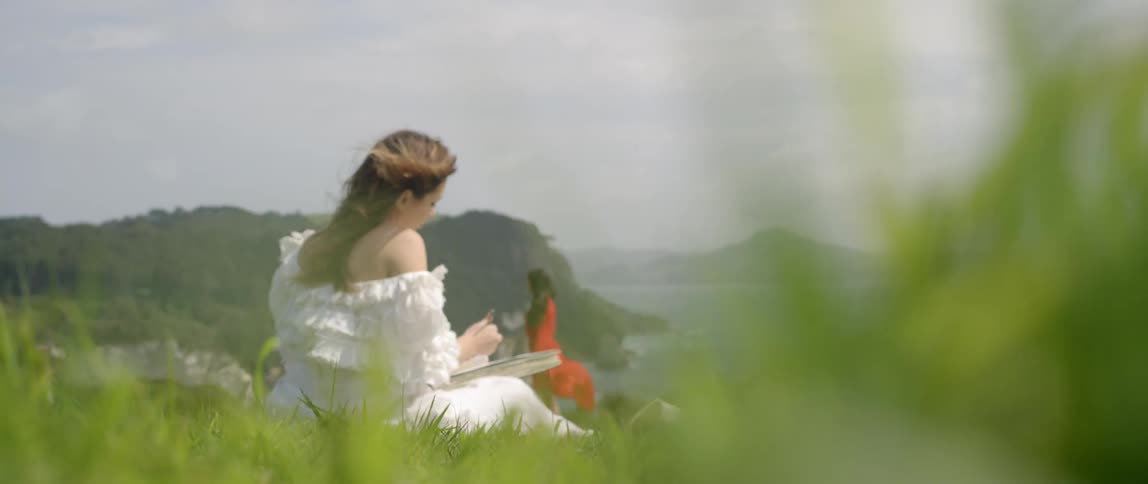 Woman draws a sketch of another woman on a windy day