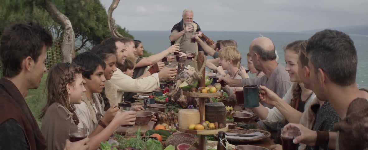 A group of people dine at a table outdoors