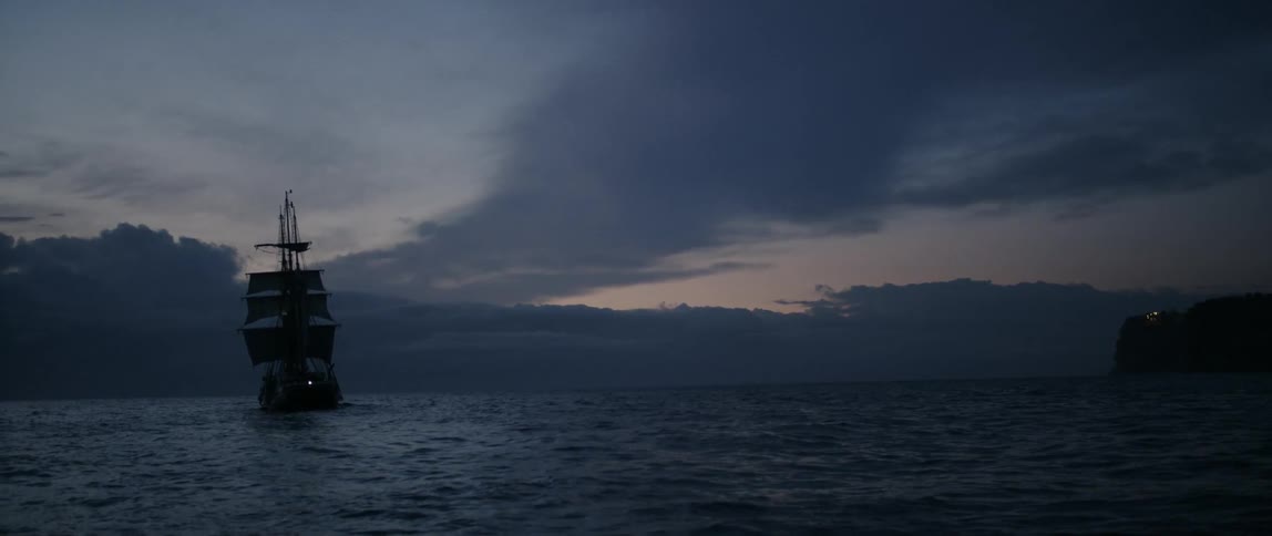 A boat is sailing at dawn in the rough waters
