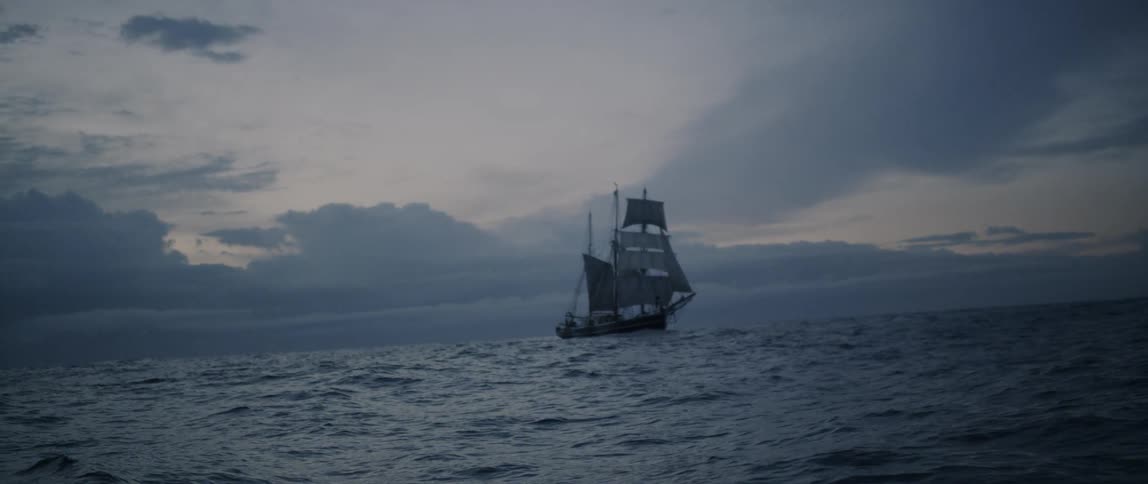 A boat is sailing in the dark waters ahead