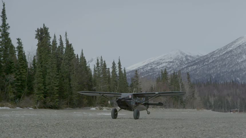 A small plane lands at a mountain airport