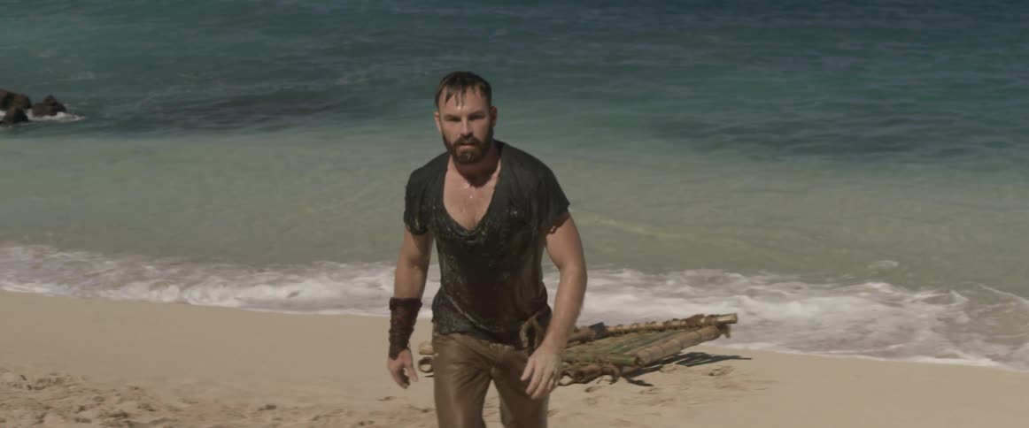 A man walks from a raft by the water