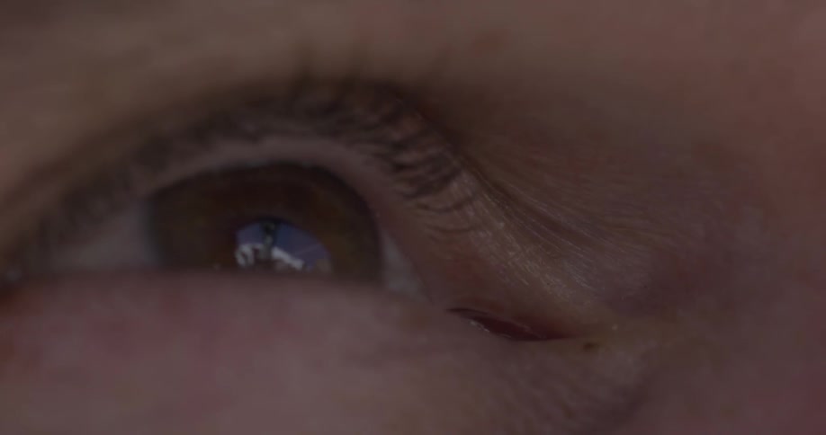 The reflection of a person is seen in an eye