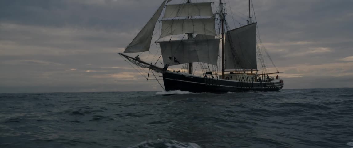 Ship sails in the ocean at sunset