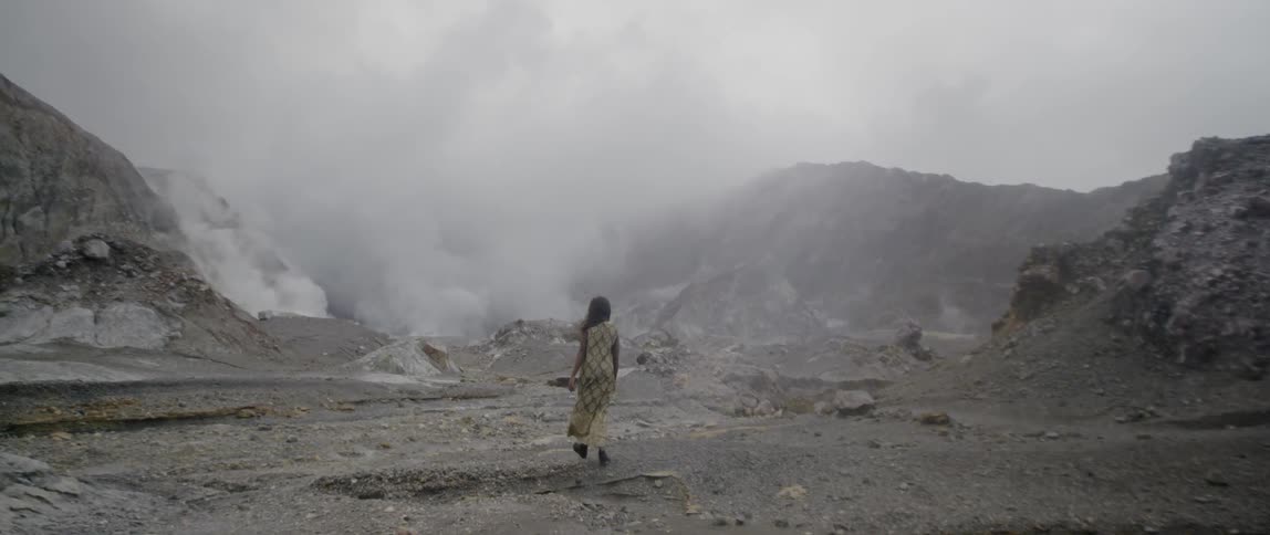 A woman is hiking near the mountain