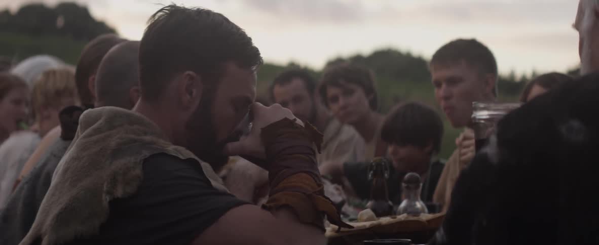 People sit outside and drink, talk, and eat
