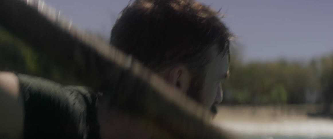 A man is rowing very hard to get away from something in the water