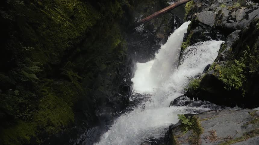 Water rushes down a waterfall into the basin below