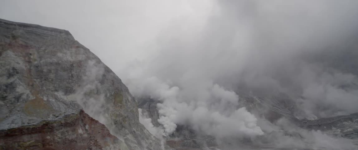 Clouds cover rocky mountain peaks and ridges
