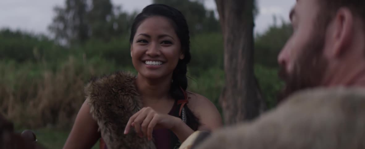 A woman laughs as she talks with friends