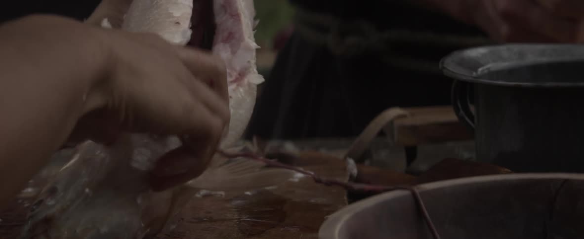 Someone is cleaning the guts from a fish