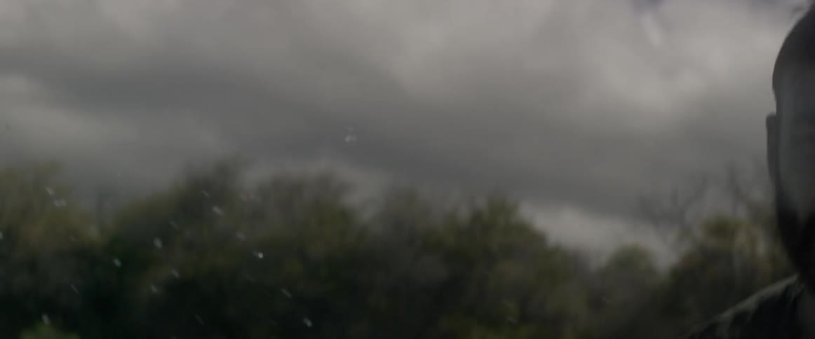 Man rowing on the water on a cloudy day